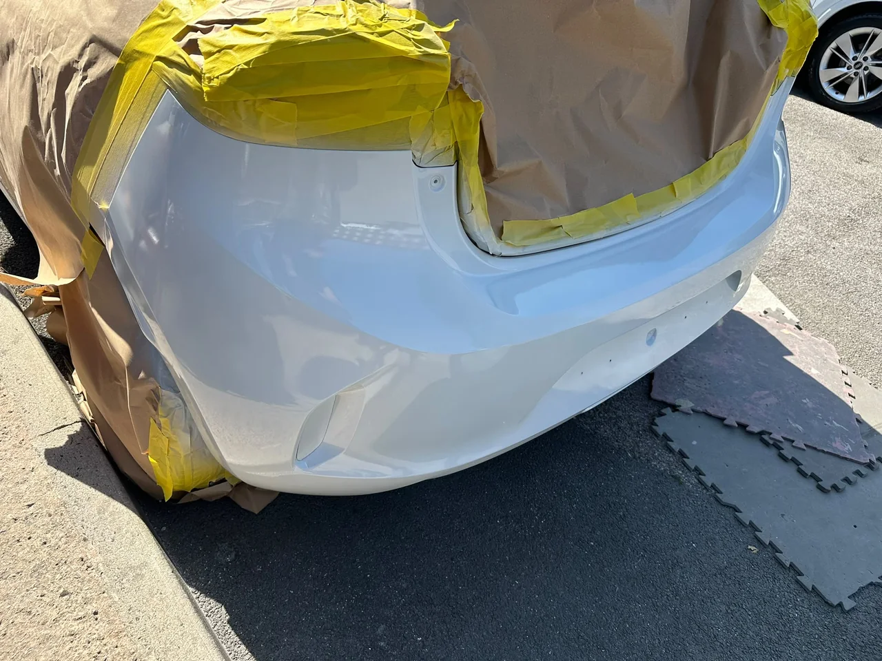 Finished white rear bumper following cosmetic repair by Vehicle Repair Experts